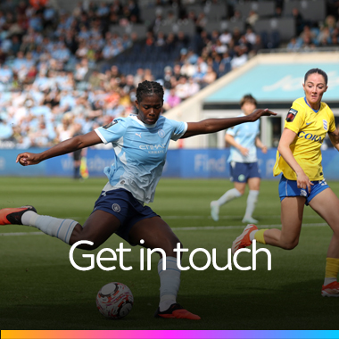 Women’s football match, with a Manchester City player striking the ball.