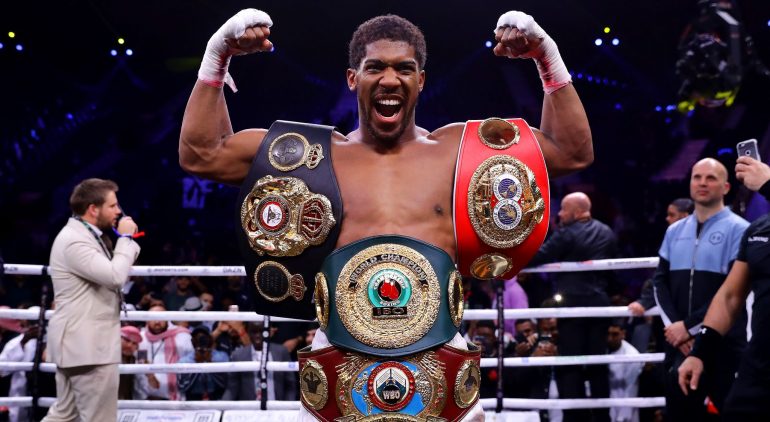 DIRIYAH, SAUDI ARABIA - DECEMBER 07: Anthony Joshua poses for a photo with the IBF, WBA, WBO & IBO World Heavyweight Title belts after the IBF, WBA, WBO & IBO World Heavyweight Title Fight between Andy Ruiz Jr and Anthony Joshua during the Matchroom Boxing 'Clash on the Dunes' show at the Diriyah Season on December 07, 2019 in Diriyah, Saudi Arabia (Photo by Richard Heathcote/Getty Images)
