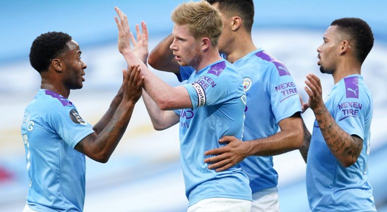 MANCHESTER, ENGLAND - JULY 02: Kevin De Bruyne of Manchester City celebrates with Raheem Sterling and Gabriel Jesus after scoring his team's first goal during the Premier League match between Manchester City and Liverpool FC at Etihad Stadium on July 02, 2020 in Manchester, England. Football Stadiums around Europe remain empty due to the Coronavirus Pandemic as Government social distancing laws prohibit fans inside venues resulting in all fixtures being played behind closed doors. (Photo by Dave Thompson/Pool via Getty Images)