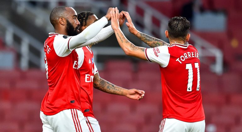 LONDON, ENGLAND - JULY 15: Alexandre Lacazette of Arsenal celebrates with teammate Lucas Torreira of Arsenal after scoring his team's first goal during the Premier League match between Arsenal FC and Liverpool FC at Emirates Stadium on July 15, 2020 in London, England. Football Stadiums around Europe remain empty due to the Coronavirus Pandemic as Government social distancing laws prohibit fans inside venues resulting in all fixtures being played behind closed doors. (Photo by Glyn Kirk/Pool via Getty Images)