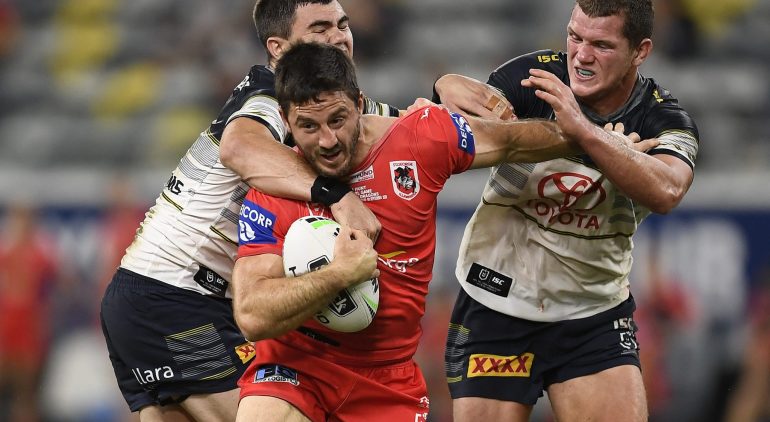 TOWNSVILLE, AUSTRALIA - SEPTEMBER 06: Ben Hunt of the Dragons is tackled by Tom Gilbert and Jake Clifford of the Cowboys during the round 17 NRL match between the North Queensland Cowboys and the St George Illawarra Dragons at QCB Stadium on September 06, 2020 in Townsville, Australia. (Photo by Ian Hitchcock/Getty Images)
